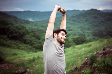 Handsome man hands stretch lazily at nature,Happy and smiling,Travel at outdoor