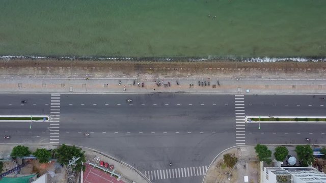 This is still a camera filming a road on the seashore on which the transport goes. In Vietnam