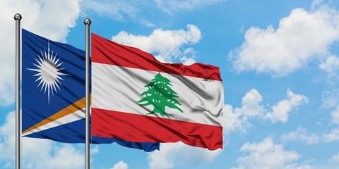 Marshall Islands and Lebanon flag waving in the wind against white cloudy blue sky together. Diplomacy concept, international relations.