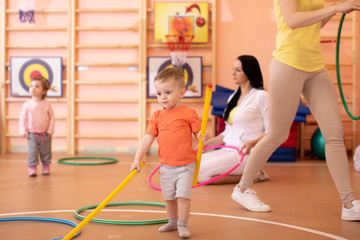 Kids with moms in gym. Healthy lifestyle and baby sport concept
