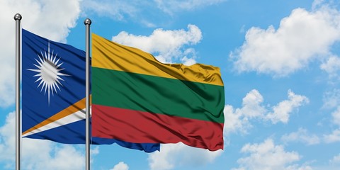 Marshall Islands and Lithuania flag waving in the wind against white cloudy blue sky together. Diplomacy concept, international relations.
