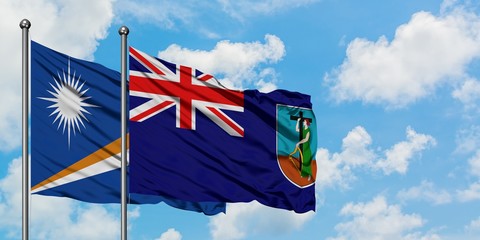 Marshall Islands and Montserrat flag waving in the wind against white cloudy blue sky together. Diplomacy concept, international relations.