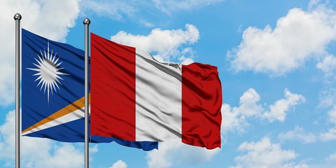 Marshall Islands and Peru flag waving in the wind against white cloudy blue sky together. Diplomacy concept, international relations.