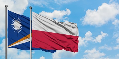 Marshall Islands and Poland flag waving in the wind against white cloudy blue sky together. Diplomacy concept, international relations.