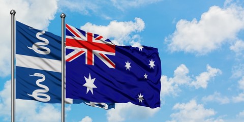 Martinique and Australia flag waving in the wind against white cloudy blue sky together. Diplomacy concept, international relations.