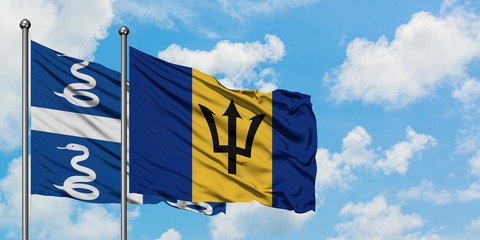 Martinique and Barbados flag waving in the wind against white cloudy blue sky together. Diplomacy concept, international relations.