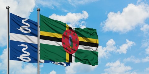 Martinique and Dominica flag waving in the wind against white cloudy blue sky together. Diplomacy...