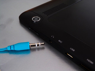 The headphone plug is next to the headphone Jack for connecting your tablet or phone. Wired headphones that are outdated. On replacement wired came wireless headphones.