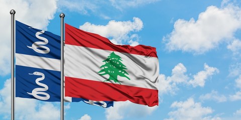 Martinique and Lebanon flag waving in the wind against white cloudy blue sky together. Diplomacy concept, international relations.