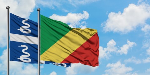 Martinique and Republic Of The Congo flag waving in the wind against white cloudy blue sky together. Diplomacy concept, international relations.