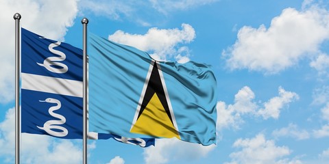 Martinique and Saint Lucia flag waving in the wind against white cloudy blue sky together. Diplomacy concept, international relations.