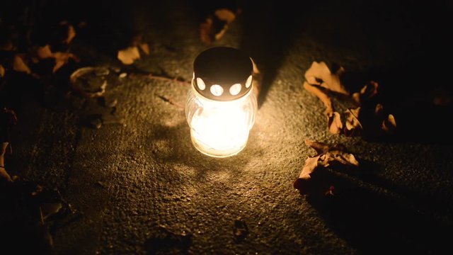 candle on a tomb on the occasion of the &rdquo;Day of the Dead&rdquo;