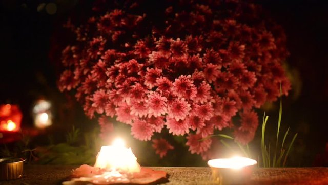 tomb decorated with flowers and candles on the occasion of the &rdquo;Day of the Dead&rdquo;