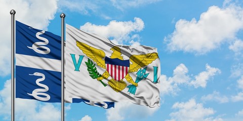 Martinique and United States Virgin Islands flag waving in the wind against white cloudy blue sky together. Diplomacy concept, international relations.