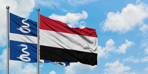 Martinique and Yemen flag waving in the wind against white cloudy blue sky together. Diplomacy concept, international relations.