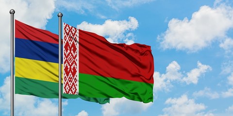 Mauritius and Belarus flag waving in the wind against white cloudy blue sky together. Diplomacy concept, international relations.