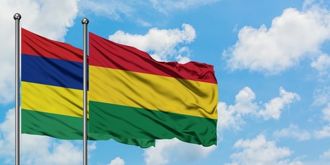 Mauritius and Bolivia flag waving in the wind against white cloudy blue sky together. Diplomacy concept, international relations.