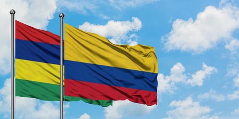 Mauritius and Colombia flag waving in the wind against white cloudy blue sky together. Diplomacy concept, international relations.