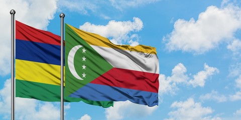 Mauritius and Comoros flag waving in the wind against white cloudy blue sky together. Diplomacy concept, international relations.