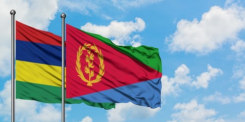 Mauritius and Eritrea flag waving in the wind against white cloudy blue sky together. Diplomacy concept, international relations.