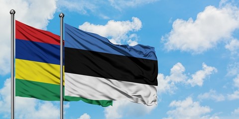 Mauritius and Estonia flag waving in the wind against white cloudy blue sky together. Diplomacy concept, international relations.