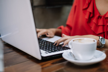 Fototapeta premium Freelance woman working on laptop at restaurant