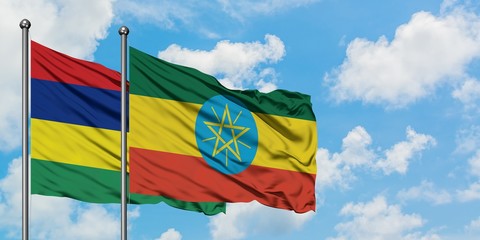 Mauritius and Ethiopia flag waving in the wind against white cloudy blue sky together. Diplomacy concept, international relations.