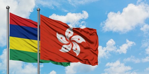 Mauritius and Hong Kong flag waving in the wind against white cloudy blue sky together. Diplomacy concept, international relations.