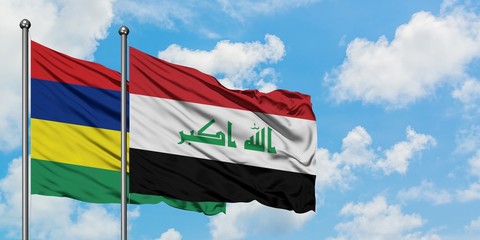 Mauritius and Iraq flag waving in the wind against white cloudy blue sky together. Diplomacy concept, international relations.