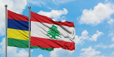 Mauritius and Lebanon flag waving in the wind against white cloudy blue sky together. Diplomacy concept, international relations.