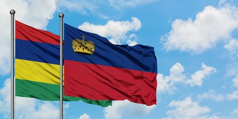 Mauritius and Liechtenstein flag waving in the wind against white cloudy blue sky together. Diplomacy concept, international relations.