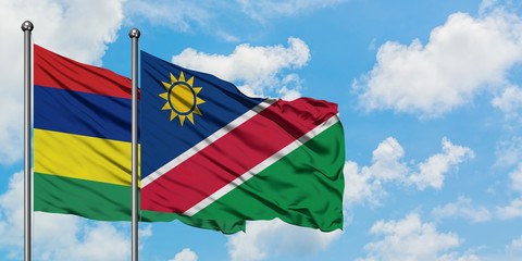Mauritius and Namibia flag waving in the wind against white cloudy blue sky together. Diplomacy concept, international relations.