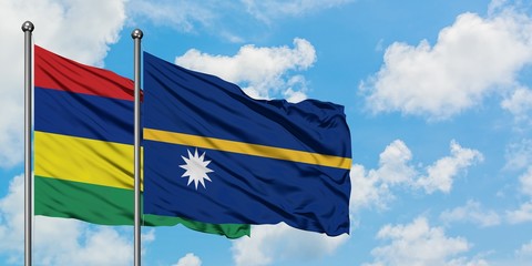 Mauritius and Nauru flag waving in the wind against white cloudy blue sky together. Diplomacy concept, international relations.