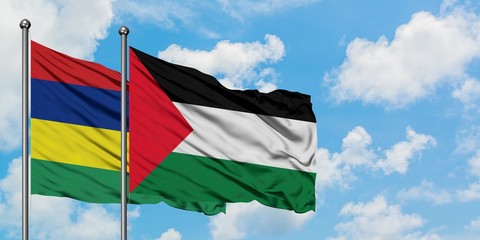 Mauritius and Palestine flag waving in the wind against white cloudy blue sky together. Diplomacy concept, international relations.