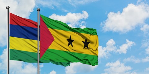 Mauritius and Sao Tome And Principe flag waving in the wind against white cloudy blue sky together. Diplomacy concept, international relations.