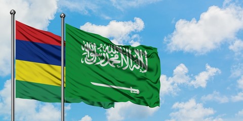 Mauritius and Saudi Arabia flag waving in the wind against white cloudy blue sky together. Diplomacy concept, international relations.