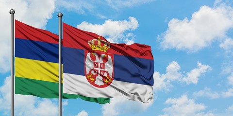 Mauritius and Serbia flag waving in the wind against white cloudy blue sky together. Diplomacy concept, international relations.
