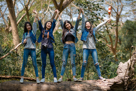 Tourist Group Cute Girl Traveler Standing Happily On A Large Piece Of Wood And Holding Both Hands On The Way To Camping Camping And Travelers Concept.