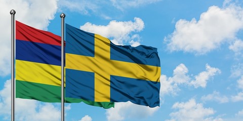 Mauritius and Sweden flag waving in the wind against white cloudy blue sky together. Diplomacy concept, international relations.