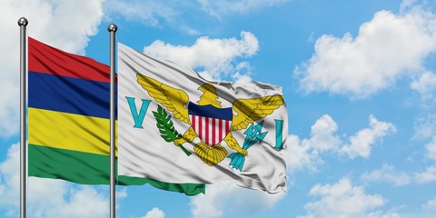 Mauritius and United States Virgin Islands flag waving in the wind against white cloudy blue sky together. Diplomacy concept, international relations.