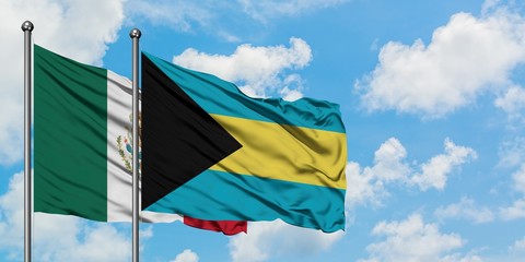 Mexico and Bahamas flag waving in the wind against white cloudy blue sky together. Diplomacy concept, international relations.