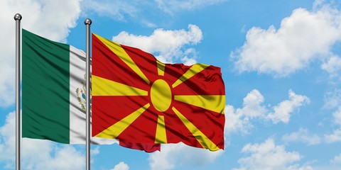 Mexico and Macedonia flag waving in the wind against white cloudy blue sky together. Diplomacy concept, international relations.