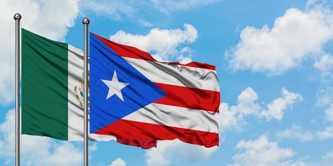 Mexico and Puerto Rico flag waving in the wind against white cloudy blue sky together. Diplomacy concept, international relations.