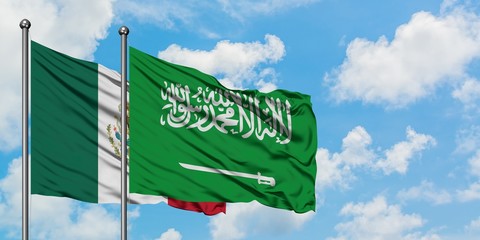 Mexico and Saudi Arabia flag waving in the wind against white cloudy blue sky together. Diplomacy concept, international relations.