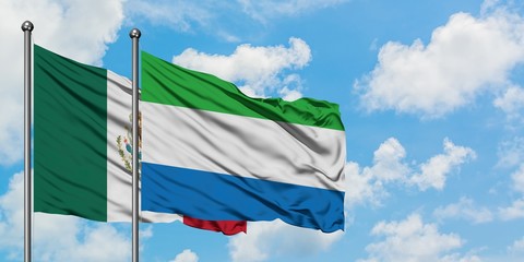 Mexico and Sierra Leone flag waving in the wind against white cloudy blue sky together. Diplomacy concept, international relations.