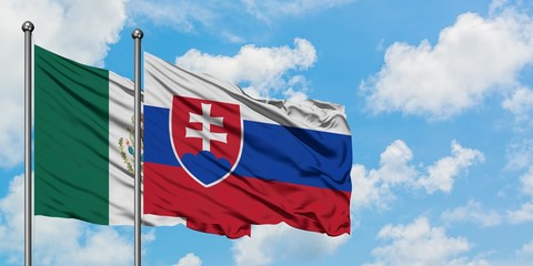 Mexico and Slovakia flag waving in the wind against white cloudy blue sky together. Diplomacy concept, international relations.