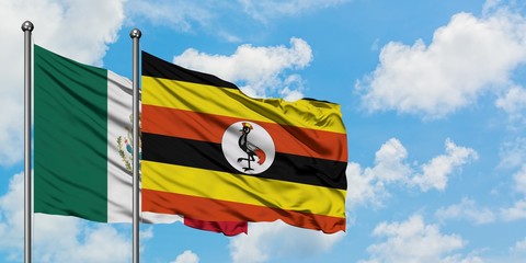 Mexico and Uganda flag waving in the wind against white cloudy blue sky together. Diplomacy concept, international relations.