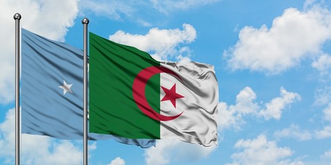 Micronesia and Algeria flag waving in the wind against white cloudy blue sky together. Diplomacy...