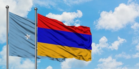 Micronesia and Armenia flag waving in the wind against white cloudy blue sky together. Diplomacy concept, international relations.