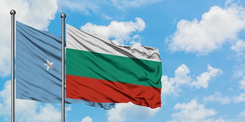 Micronesia and Bulgaria flag waving in the wind against white cloudy blue sky together. Diplomacy concept, international relations.